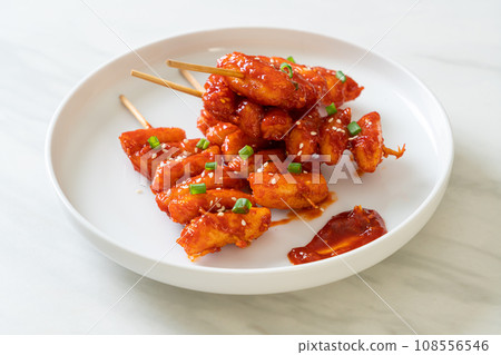 deep fried Korean rice cake (Tteokbokki) skewered with spicy sauce deep fried Korean rice cake (Tteokbokki) skewered with spicy sauce 108556546