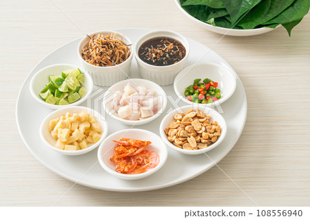 Miang kham - A royal leaf wrap appetizer Miang kham - A royal leaf wrap appetizer 108556940