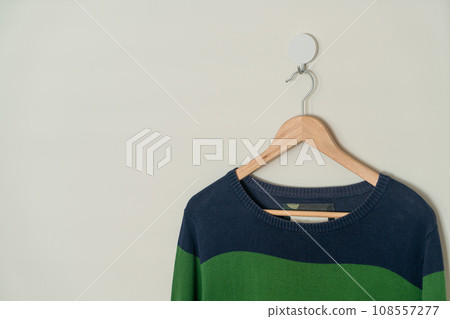 colorful sweater hanging with wood hanger 108557277