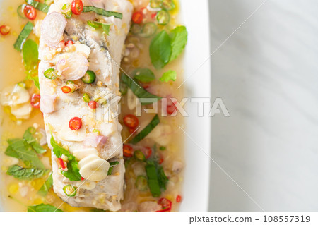 steamed sea bass fish with herbs 108557319