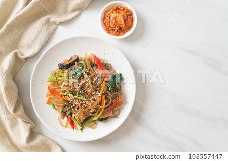 japchae or stir-fried Korean vermicelli noodles with vegetables and pork topped with white sesame japchae or stir-fried Korean vermicelli noodles with vegetables and pork topped with white sesame 108557447