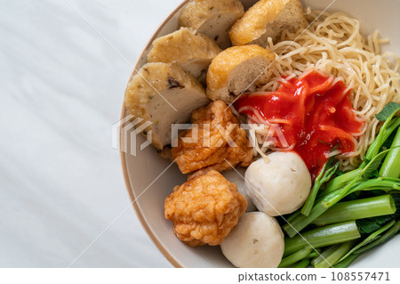 egg noodles with fish balls and shrimp balls in pink sauce, Yen Ta Four or Yen Ta Fo egg noodles with fish balls and shrimp balls in pink sauce, Yen Ta Four or Yen Ta Fo 108557471