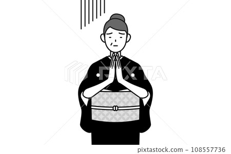 A senior woman in a kimono apologizes with her hands together in front of her body, at a New Year's shrine visit, a wedding ceremony, etc. 108557736