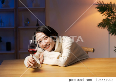 A woman drinking wine and relaxing A woman drinking wine and relaxing 108557908
