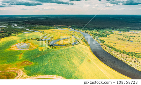 Drone Aerial View Spring Meadow Field Pasture And Curved River Marsh. Springtime Landscape. Top View From High Attitude In Summer Season. Drone View, . Bird's Eye View. Ecological Concept Background Drone Aerial View Spring Meadow Field Pasture And Curved River Marsh. Springtime Landscape. Top View From High Attitude In Summer Season. Drone View, . Bird's Eye View. Ecological Concept Background 108558728