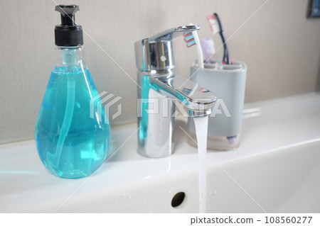 water pouring from a faucet tap slow motion  108560277