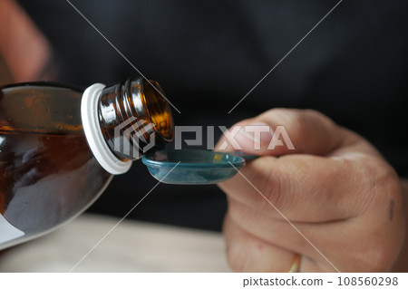 A dose of cough syrup. A dose of cough syrup. 108560298