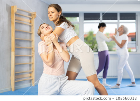Two young women training self-defense techniques Two young women training self-defense techniques 108560318