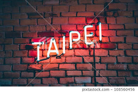Taipei words in cyan and red neon sign on brick wall Taipei words in cyan and red neon sign on brick wall 108560456