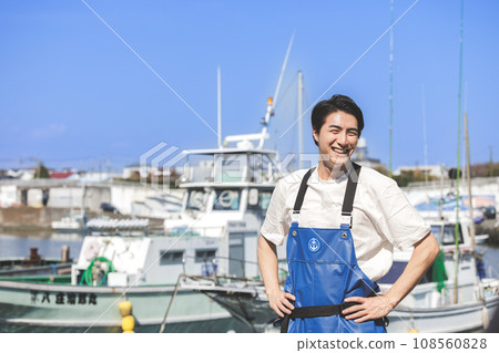 A young fisherman working at a fishing port A young fisherman working at a fishing port 108560828