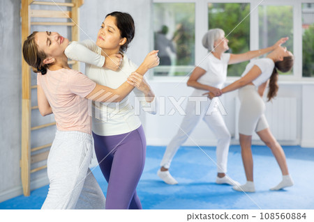 Active women are training captures on self-defense course in gym Active women are training captures on self-defense course in gym 108560884