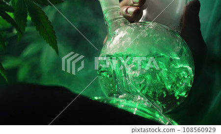 Smoking medical marijuana, glass water bong in neon light at home. Cannabis. Smoking medical marijuana, glass water bong in neon light at home. Cannabis. 108560929