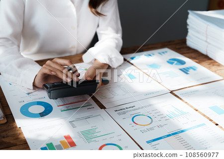 Young asian female work with financial papers at home count on calculator before paying taxes receipts online, planning budget glad to find chance for economy saving money, audit concepts. 108560977