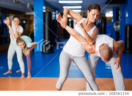 Asian woman practicing self-defence moves with her trainer 108561134