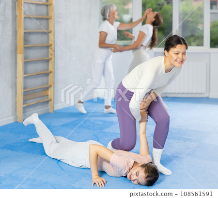 Two young women training self-defense techniques 108561591