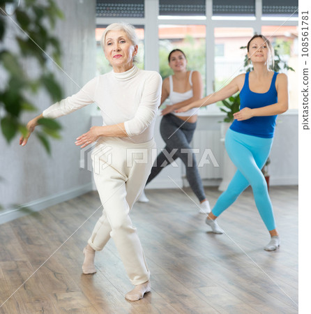 Elderly woman dancing in fitness studio Elderly woman dancing in fitness studio 108561781