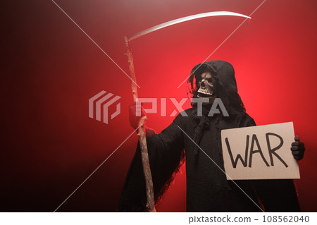 The Grim Reaper holds a poster with the inscription war. The scary grim reaper. Death Grim Reaper 108562040