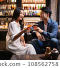 Men and women relaxing at a bar 108562758