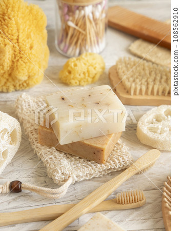 Beige handmade soap bar on soap saver bag near hygiene Items close up Beige handmade soap bar on soap saver bag near hygiene Items close up 108562910