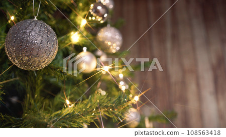 Silver ball hanging on a Christmas tree Silver ball hanging on a Christmas tree 108563418