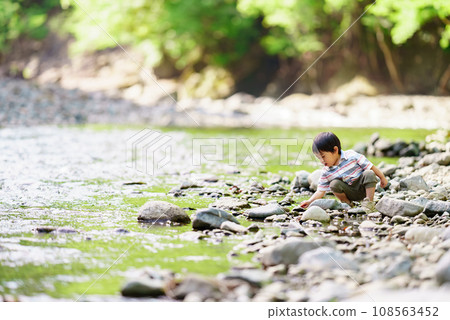 3 year old boy playing in the river 3 year old boy playing in the river 108563452