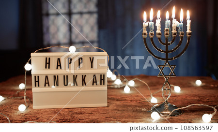 Happy Hanukkah Signboard and Candlestick on table Happy Hanukkah Signboard and Candlestick on table 108563597