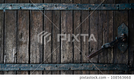 Old rotten wormy ancient oak door and metal parts, wooden textured castle door 108563668