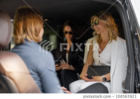 Business people sitting in minivan taxi 108563921