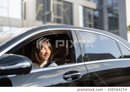 Portrait of business woman in luxury car Portrait of business woman in luxury car 108564254