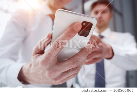 man using smartphone pressing finger, reading social media internet, typing text or shopping online. 108565065