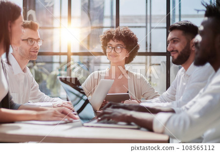 Employees working at computer together, discussing content Employees working at computer together, discussing content 108565112