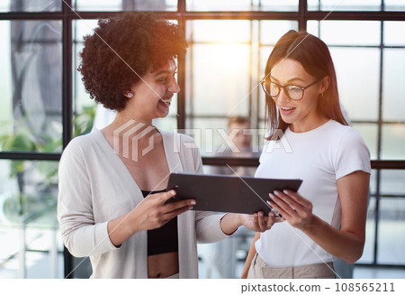 Two women analyzing documents office. Woman executives at work in office discussing some paperwork. 108565211