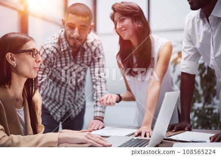 Happy young female worker discussing online project 108565224