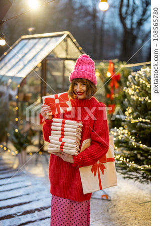 Holding stack of linen bags with New Year's bow print 108565780