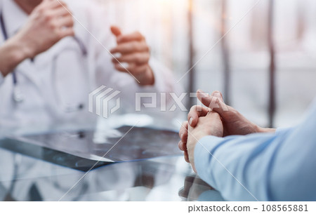 the doctor and the patient at the reception are discussing the x-ray the doctor and the patient at the reception are discussing the x-ray 108565881