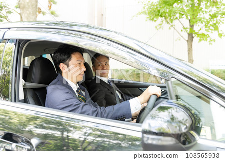 Two businessmen driving a car 108565938