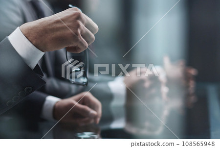 Close up of male hands holding a pair of glasses 108565948