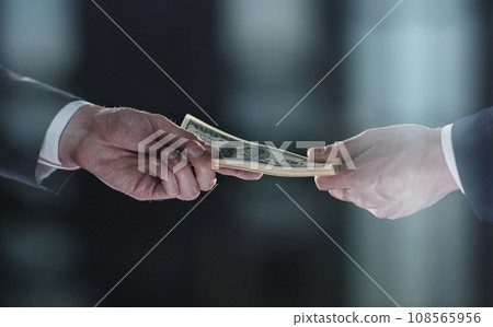 Money transfer between colleagues on a black background 108565956