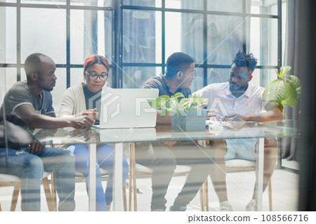 ehind the glass view of executives discussing project in modern office ehind the glass view of executives discussing project in modern office 108566716