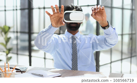 young businessman wearing virtual reality glasses in the office young businessman wearing virtual reality glasses in the office 108566719