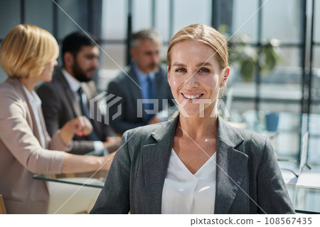 confident business woman looking at camera in modern office 108567435