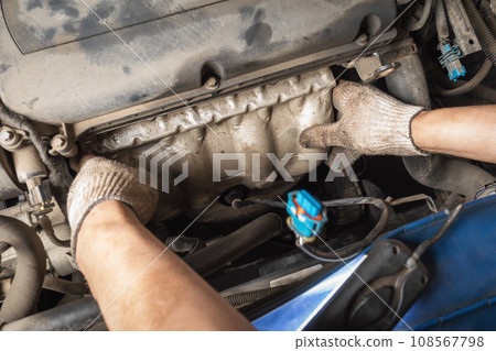 The process of installing collector protection on a car engine, a car service employee at work 108567798