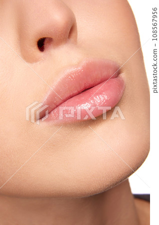 Close up view of woman full pink with natural gloss lips, closed mouth. Beautiful plump lips. After treatment, moisturized lips. Close up view of woman full pink with natural gloss lips, closed mouth. Beautiful plump lips. After treatment, moisturized lips. 108567956