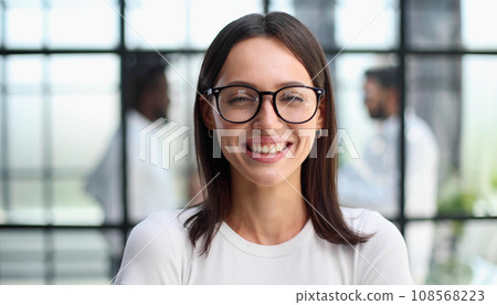 business woman with her staff in background at office business woman with her staff in background at office 108568223