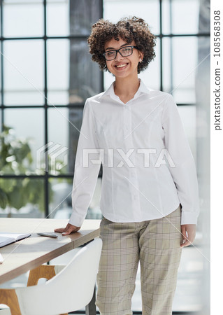 business woman writing at her desk in a modern office 108568308