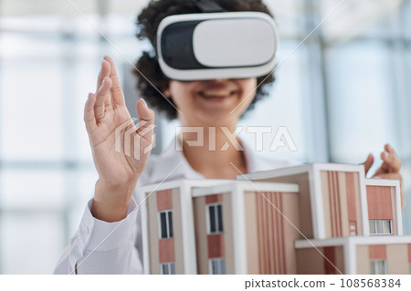female architect designer examines house layout with 3d glasses 108568384