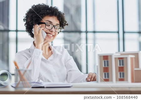 female architect designer examines house layout 108568440