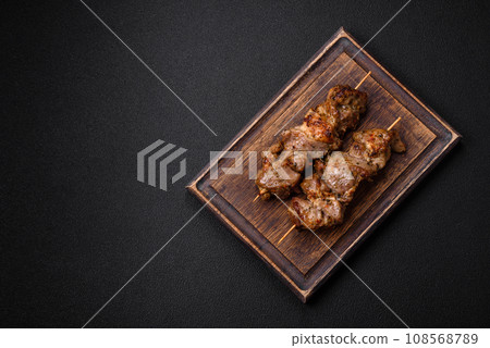 Delicious fried shish kebab of chicken or pork meat with salt, spices and herbs 108568789