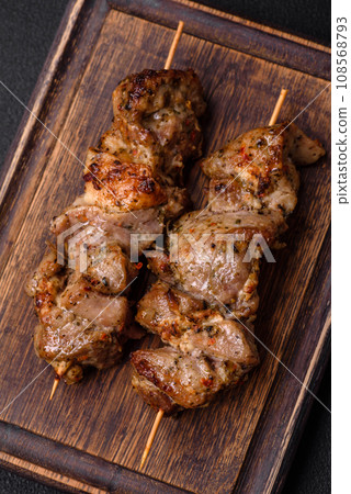 Delicious fried shish kebab of chicken or pork meat with salt, spices and herbs 108568793