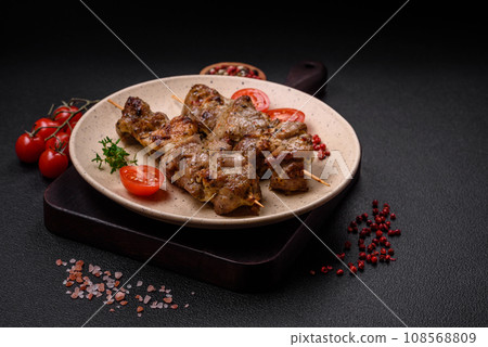 Delicious fried shish kebab of chicken or pork meat with salt, spices and herbs 108568809